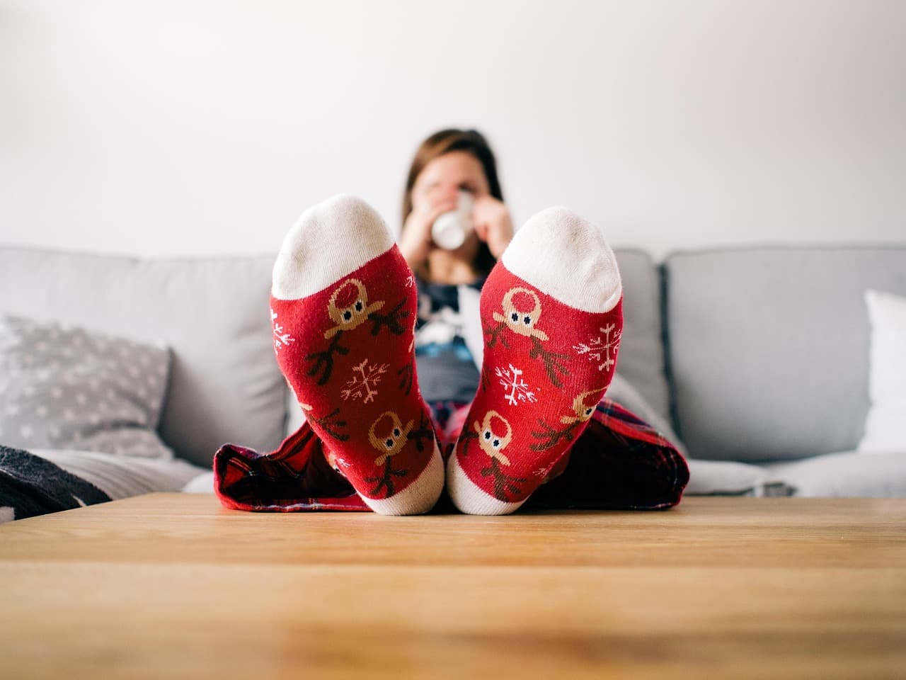 Feet up in warm socks on a sofa in a heated room
