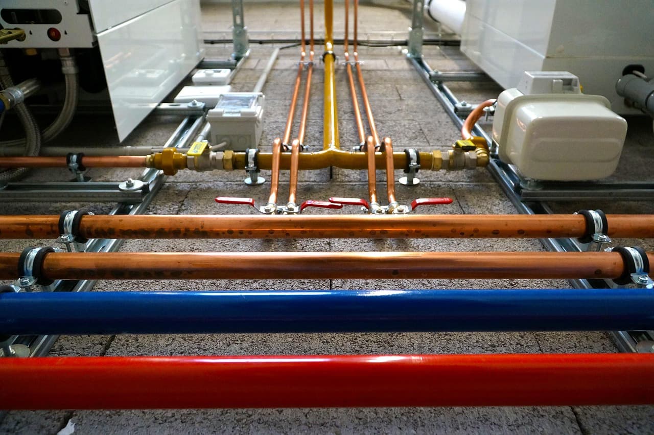 Copper flow and return pipes running under a floor