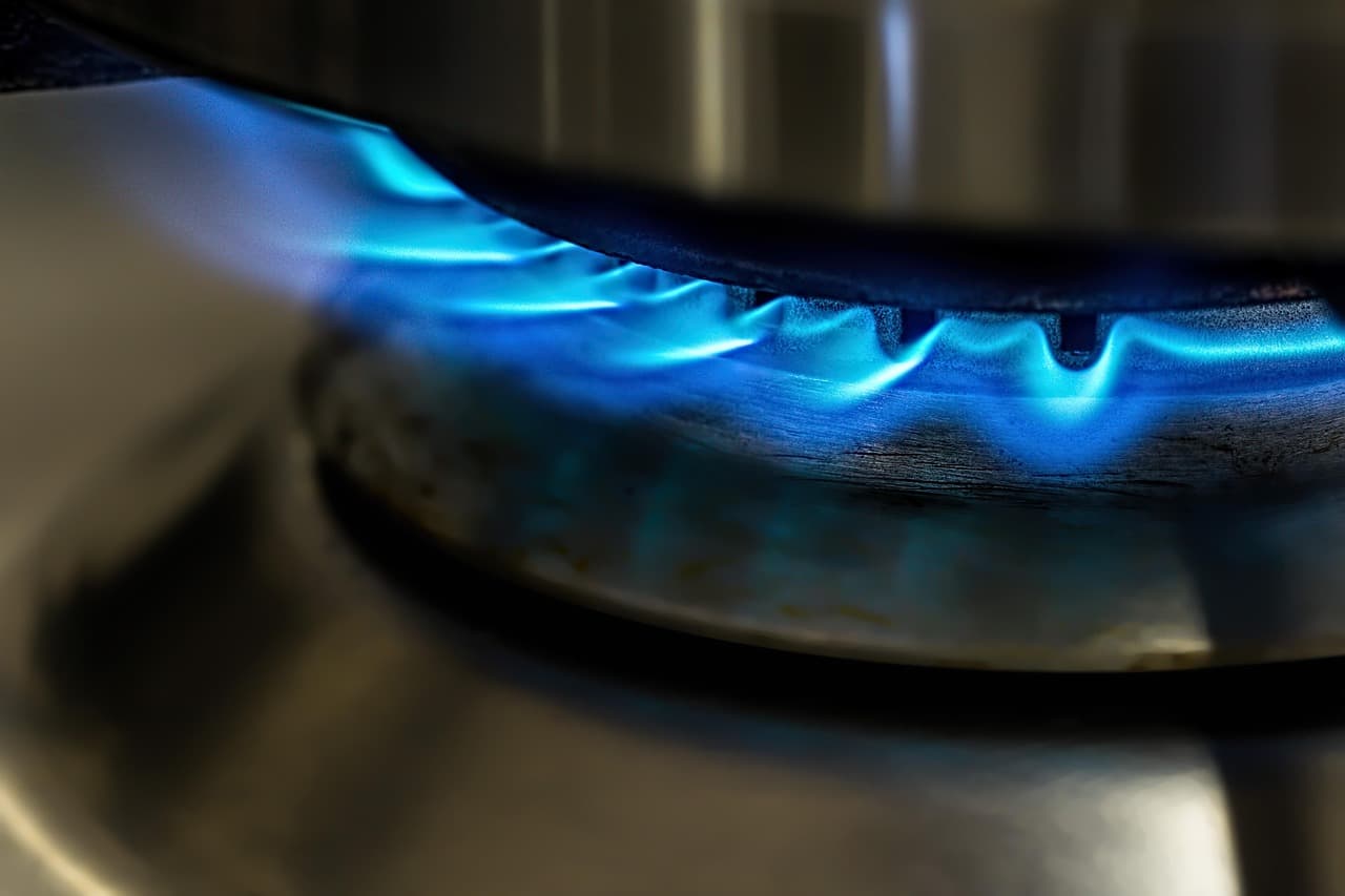 A blue gas flame on a hob burner
